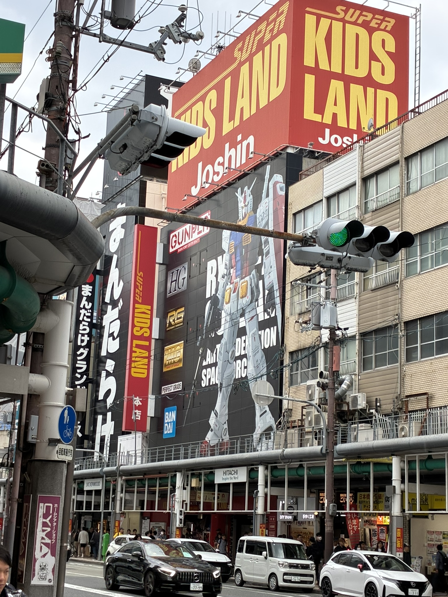 Rainy street scene near Nipponbashi with shops and pedestrians