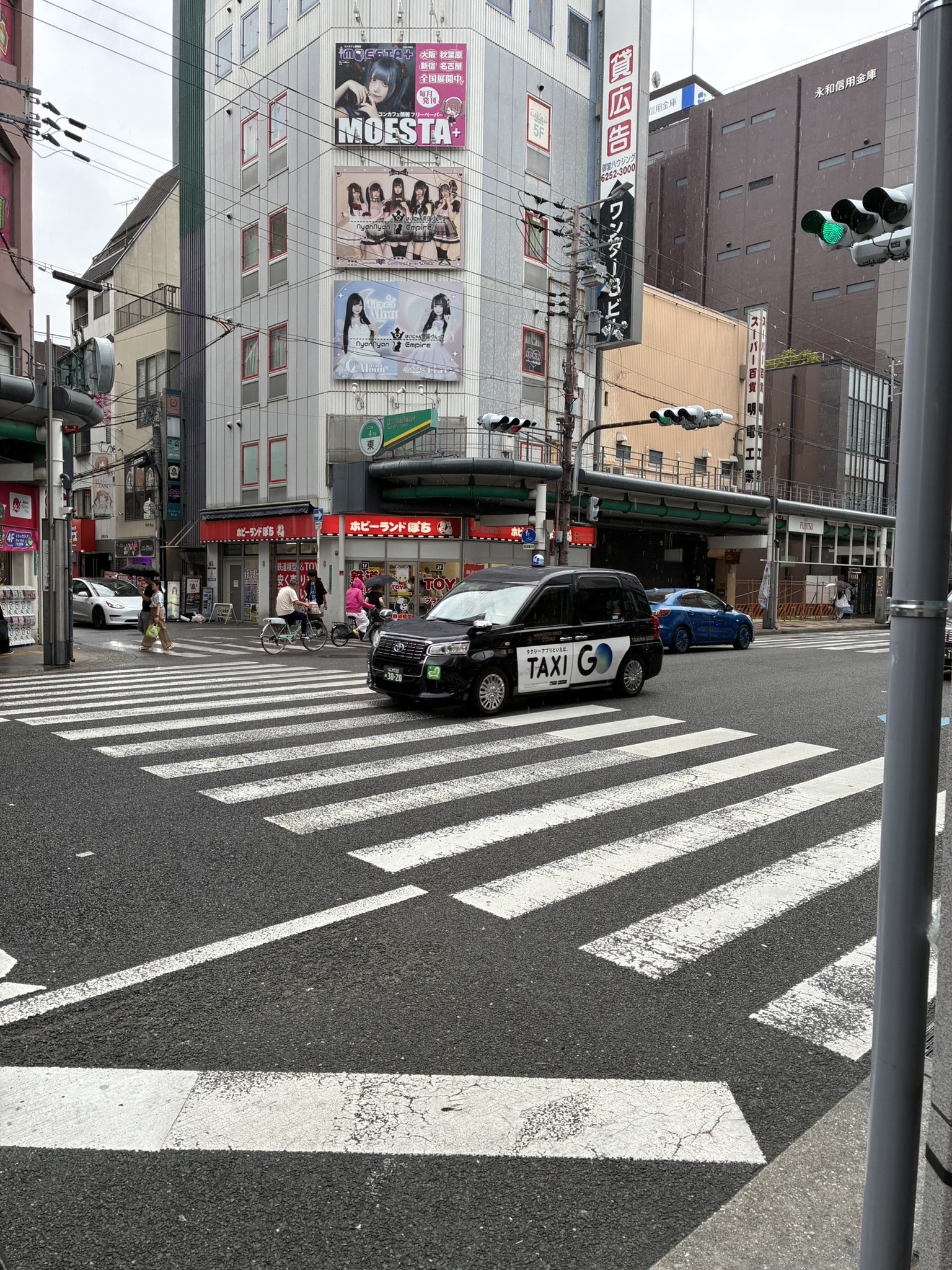 Wet street and crosswalk around Osaka Nipponbashi on a rainy day